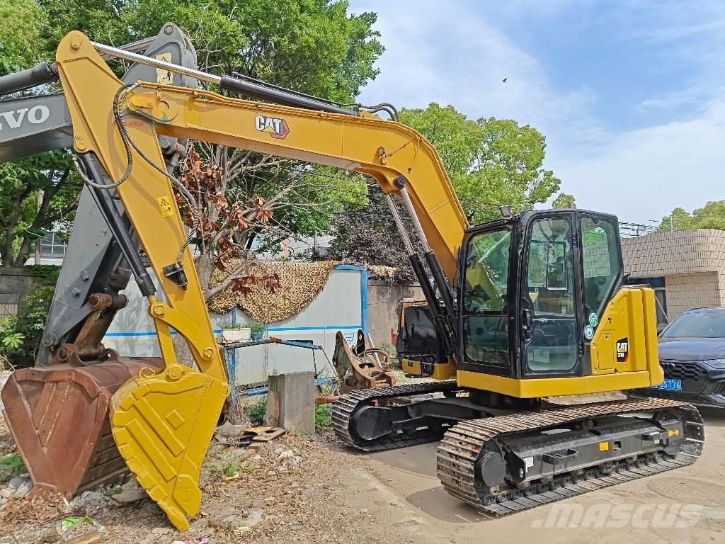 CAT 310 Rupsgraafmachines