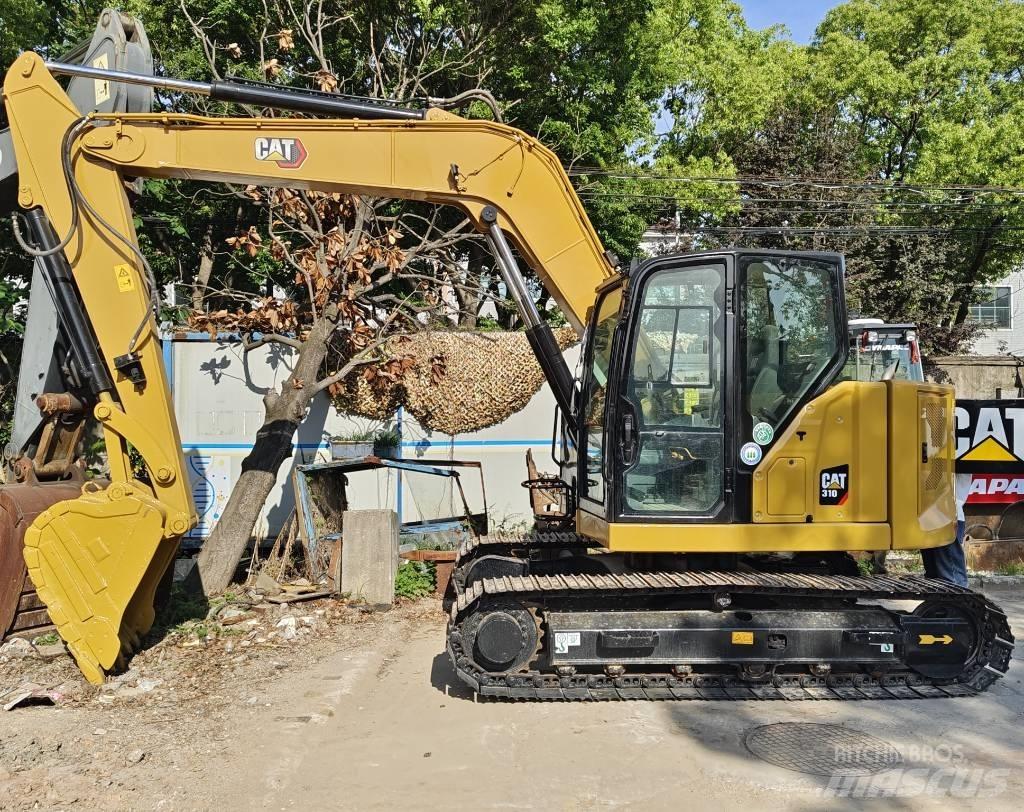 CAT 310 Rupsgraafmachines